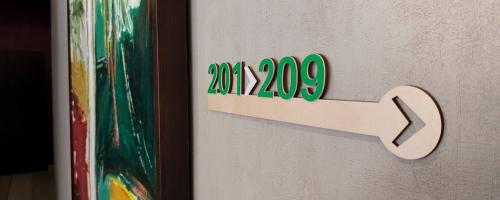 A hotel indoor directional signage made with laser wood cutting