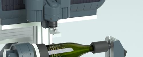 Wine bottle engraving shown on a rotary engraver installed in a rotary device